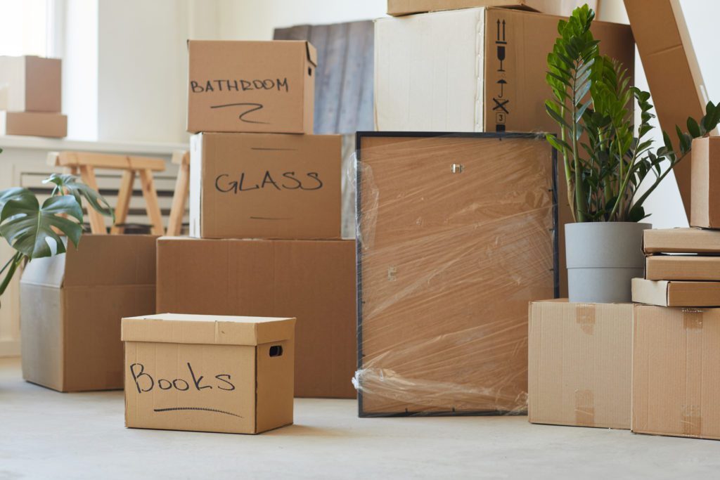 Avoid paying for moving boxes - Stack of signed cardboard boxes in the room prepared for relocation