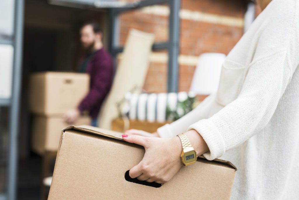 DIY Cleaning - Man and woman moving boxes