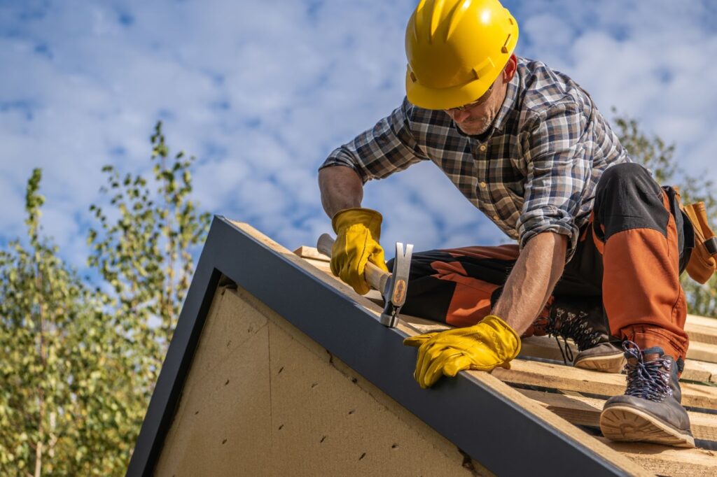 A roofer repairing the roof of a home for sale