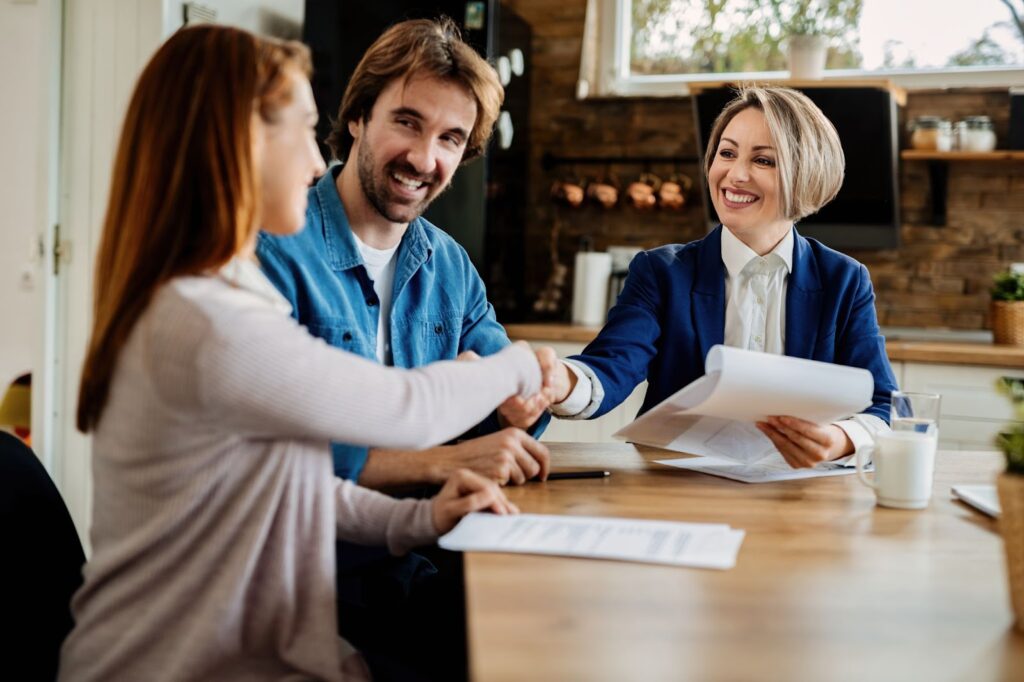 A realtor shaking hands with her client.